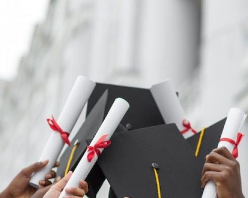 Free Photo _ Close up hands holding diplomas and caps